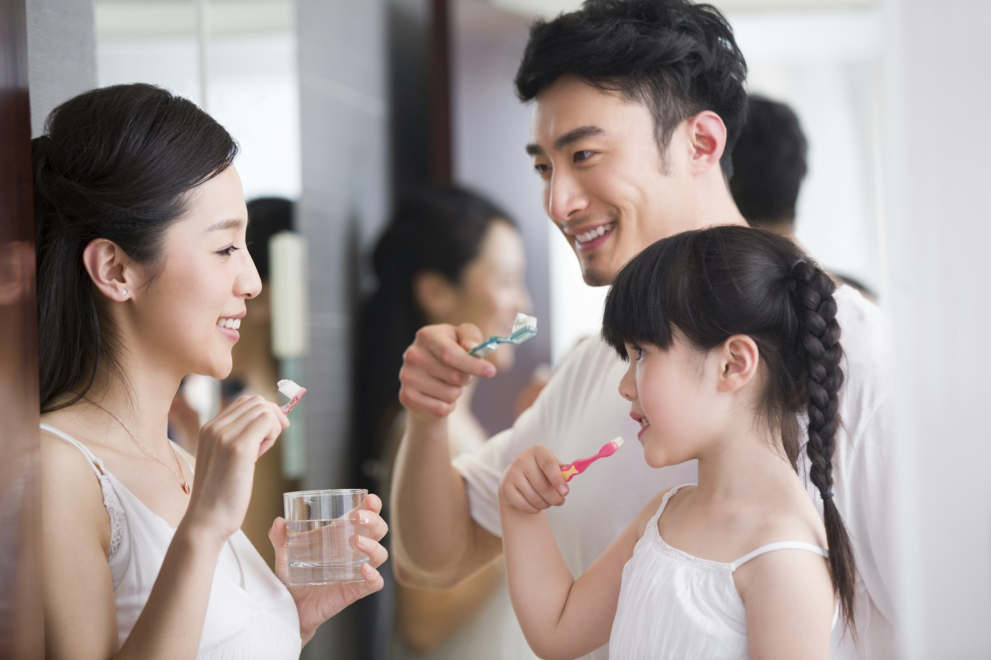 Happy family brushing teeth