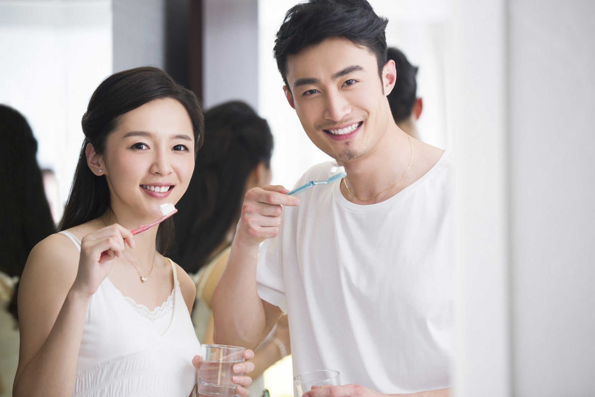 Young couple brushing teeth